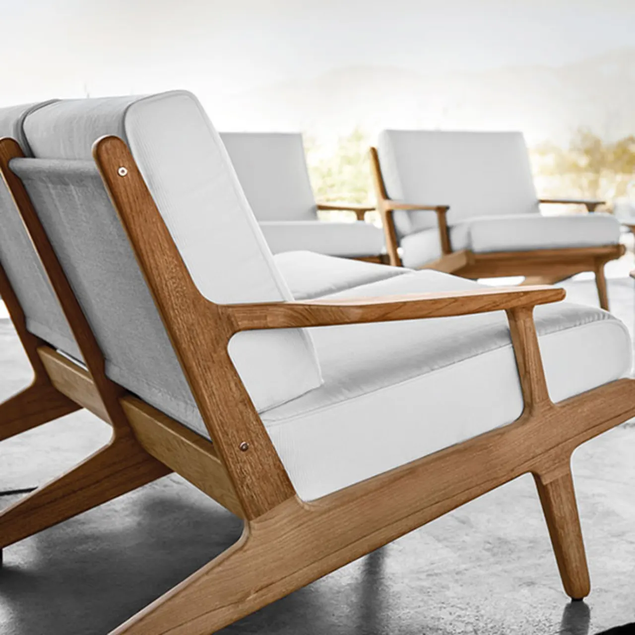 bay detail: cushions with welt and rounded teak frames